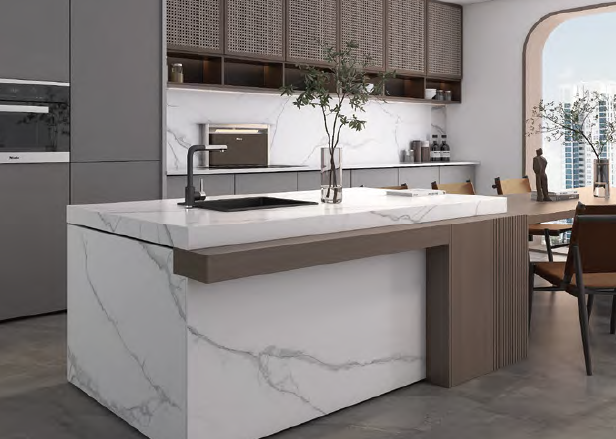 A kitchen with a large island in the middle and a sink.