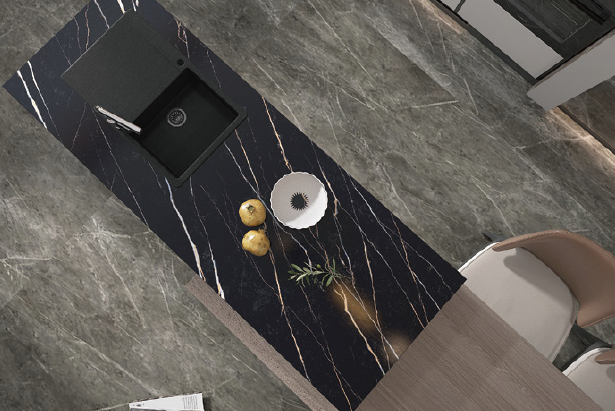 An aerial view of a kitchen with a black counter top and a sink.