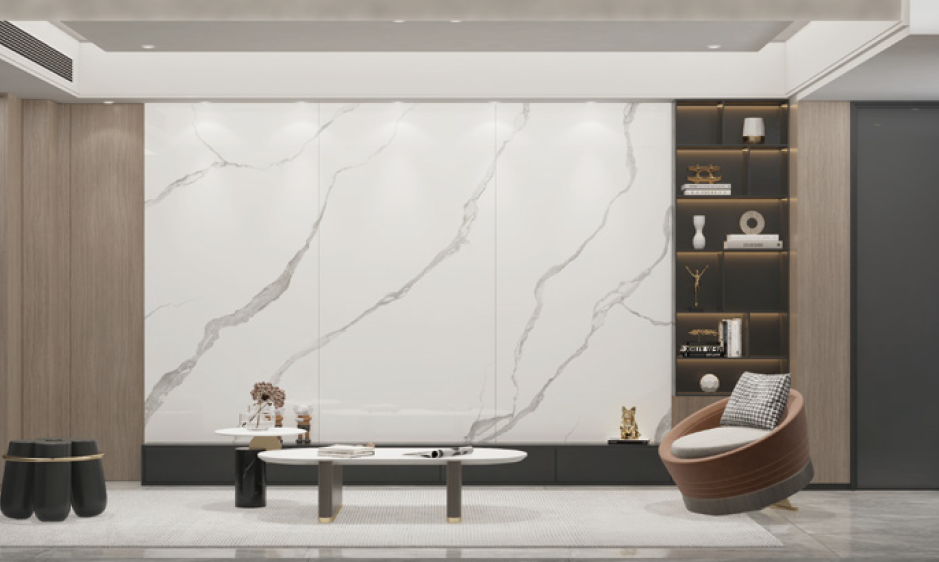 A living room with a large marble wall , a coffee table and a chair.