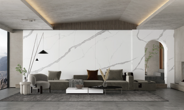 A living room with a couch , chair , coffee table and marble wall.