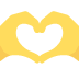A pair of yellow hands making a heart shape on a white background.