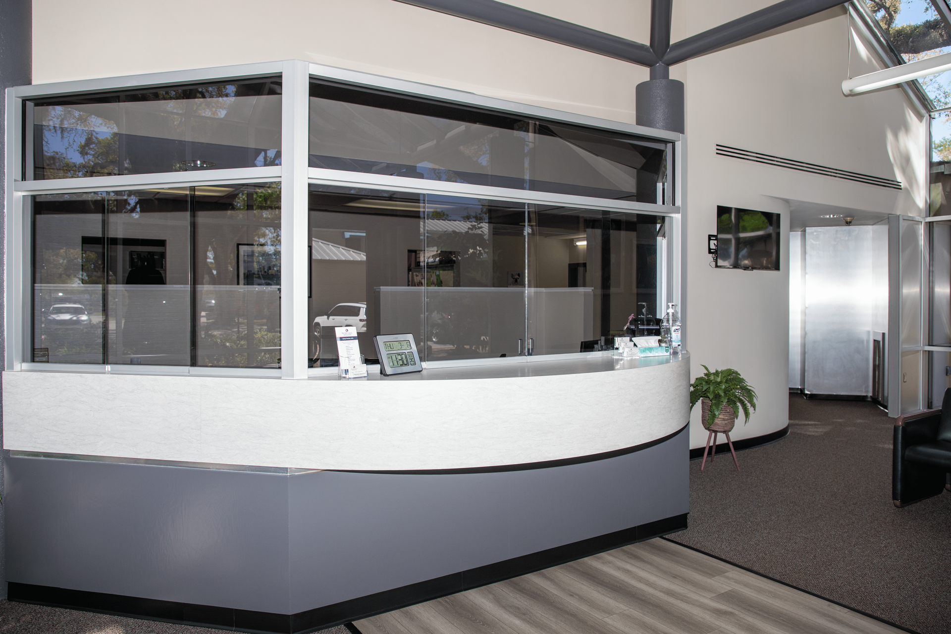 A reception desk in a building with a large window