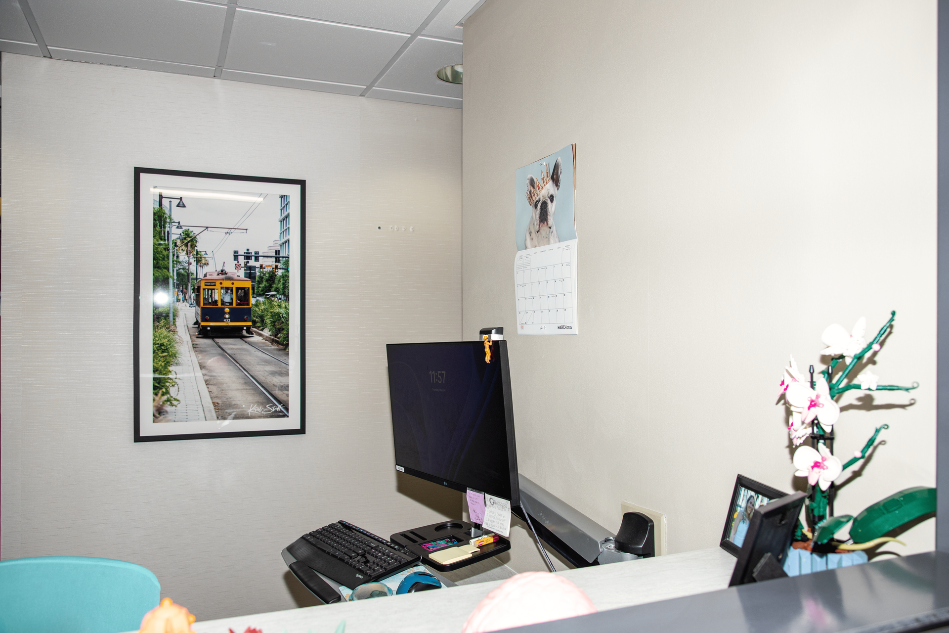 There is a picture of a train on the wall above the desk.