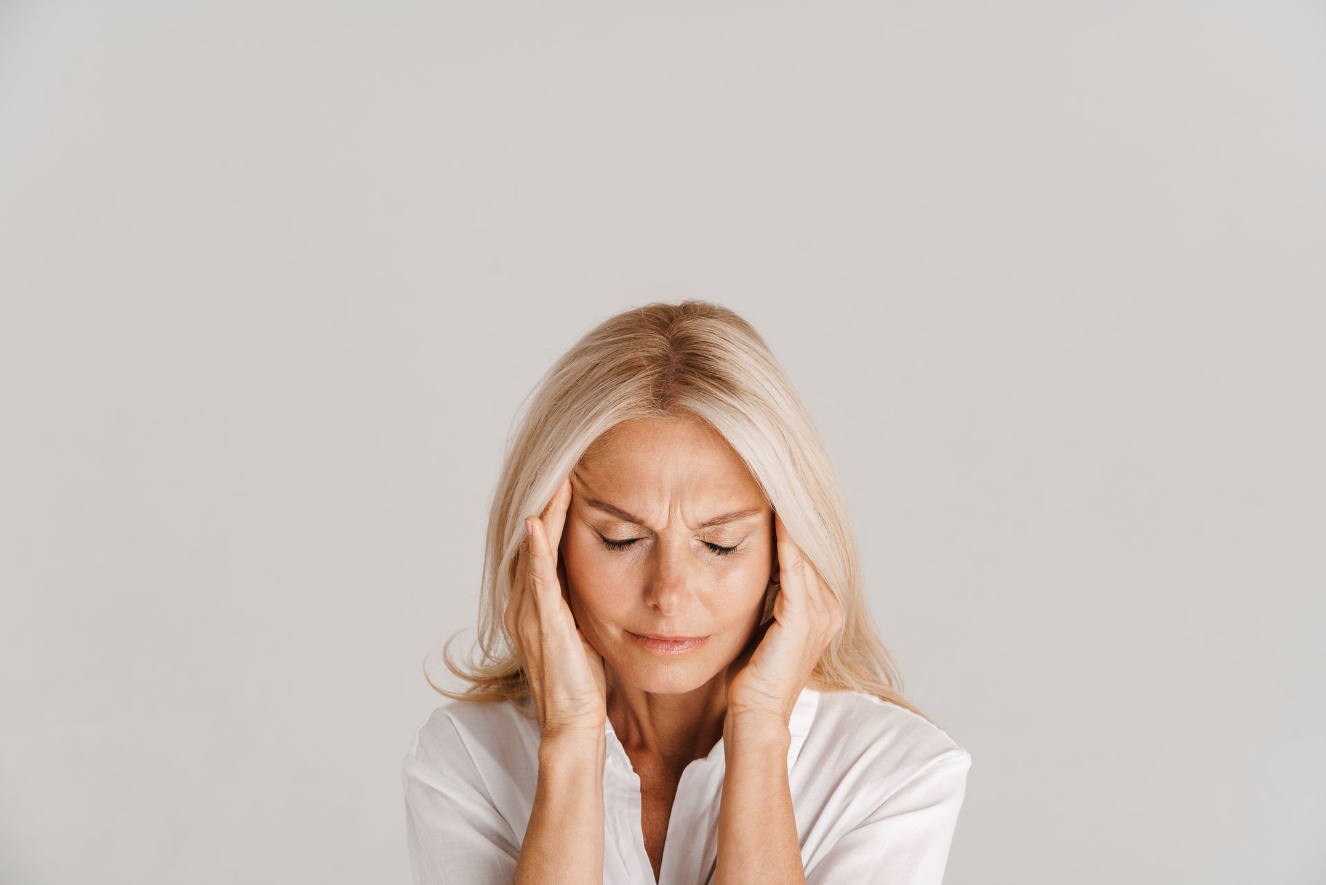woman holding her head in pain - headache specialist - neurologist in tampa fl