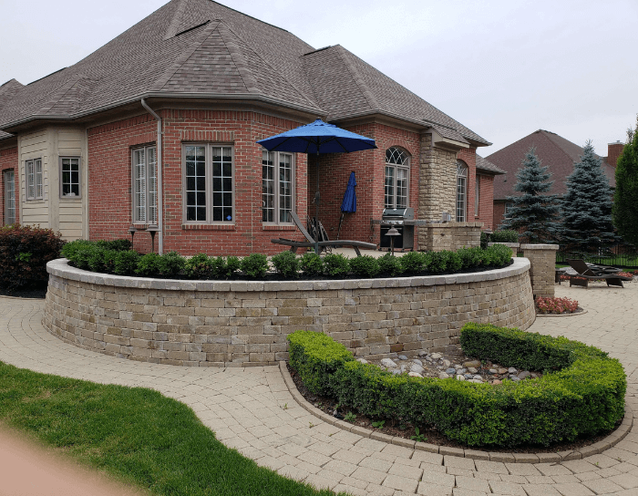 A brick house with a blue umbrella in front of it