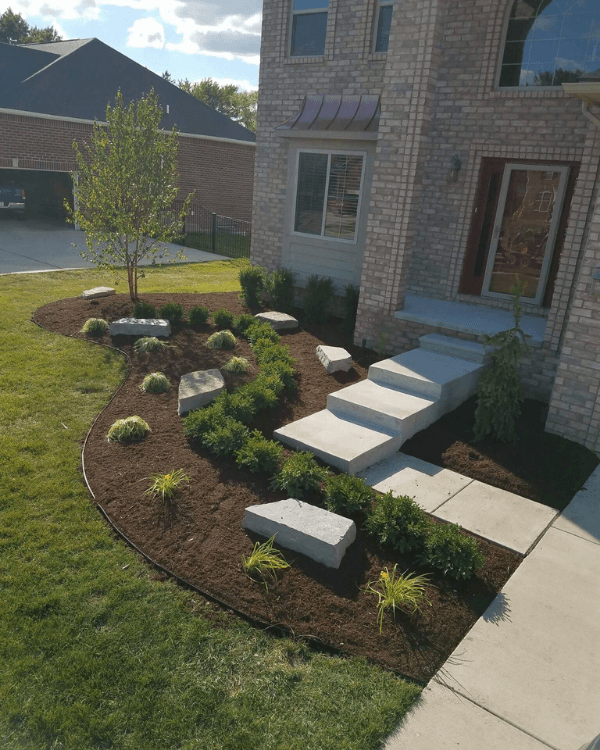 A brick house with steps leading up to the front door