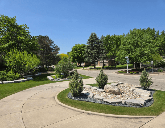 A circular driveway with a large rock in the middle