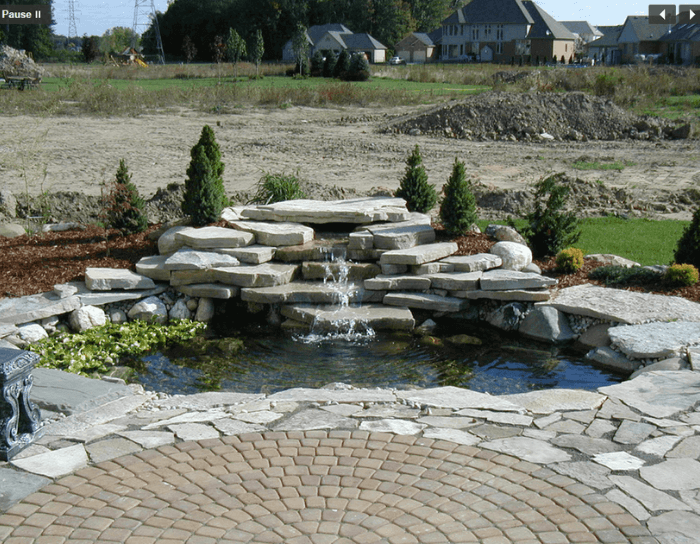 A pond with a waterfall in the middle of it