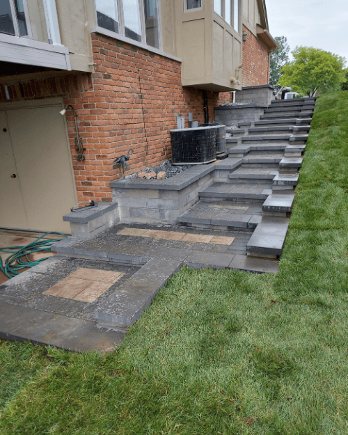 A set of stairs leading up to a brick house