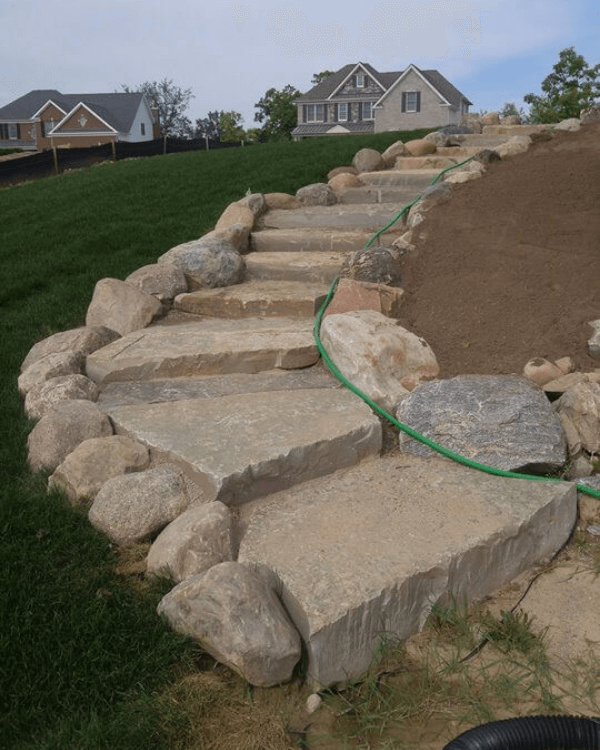 A hose is attached to a set of stone steps