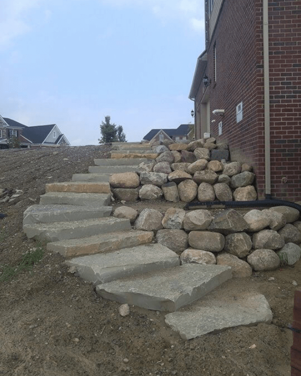 A set of stone stairs leading up to a brick building