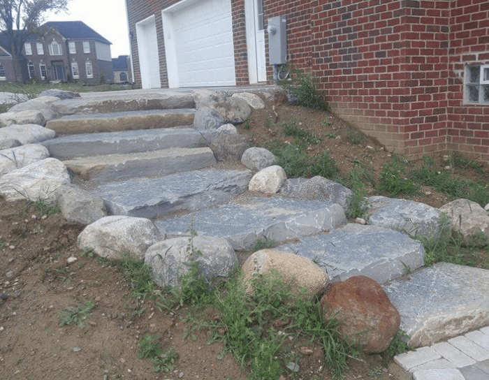A set of stone steps leading up to a brick house