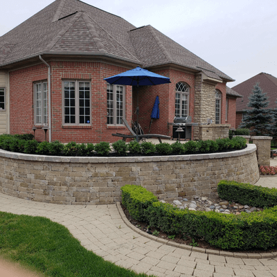 A brick house with a blue umbrella in front of it