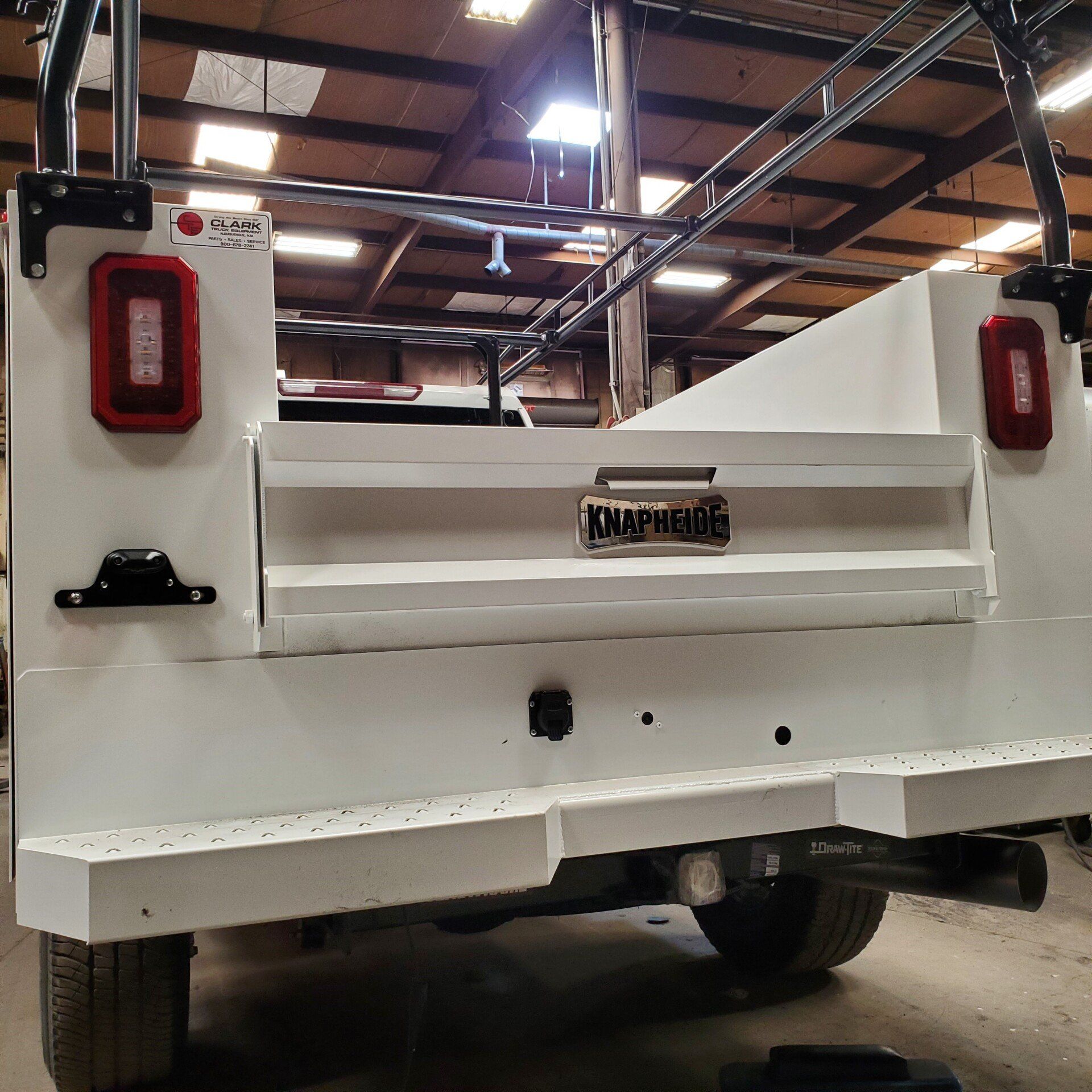 White truck bed with red taillights and a 