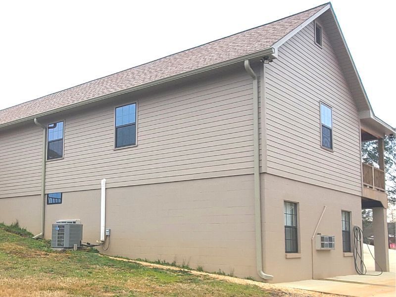 A large house with a lot of windows and a roof