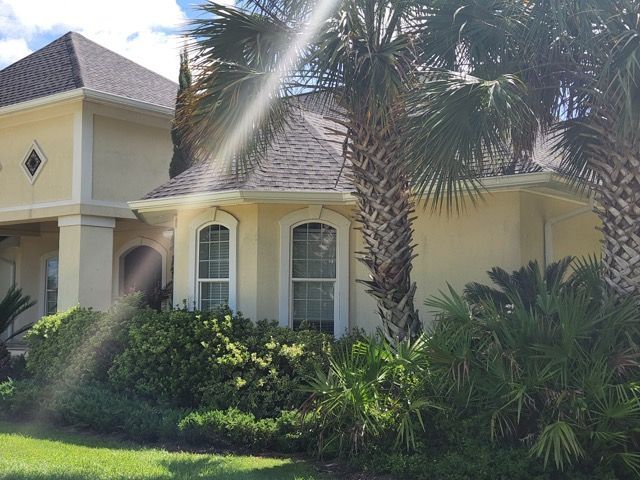 A house with palm trees in front of it