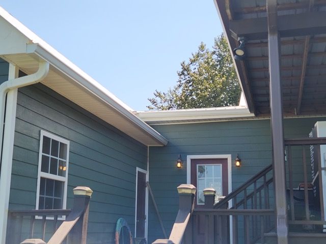 A blue house with a porch and stairs
