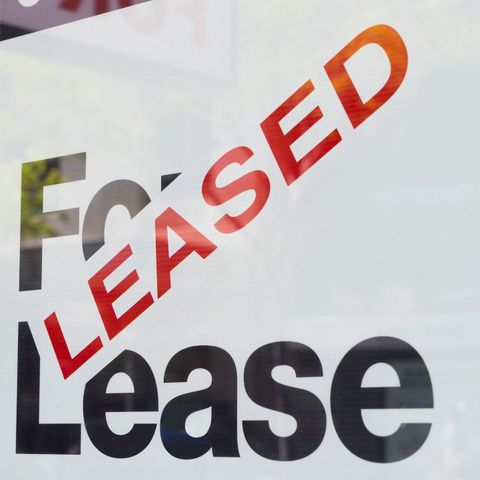 For lease and leased sign on display outside a building