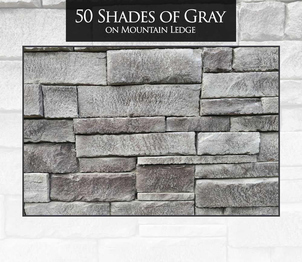 A brick wall with a sign that says 50 shades of gray on mountain ledge