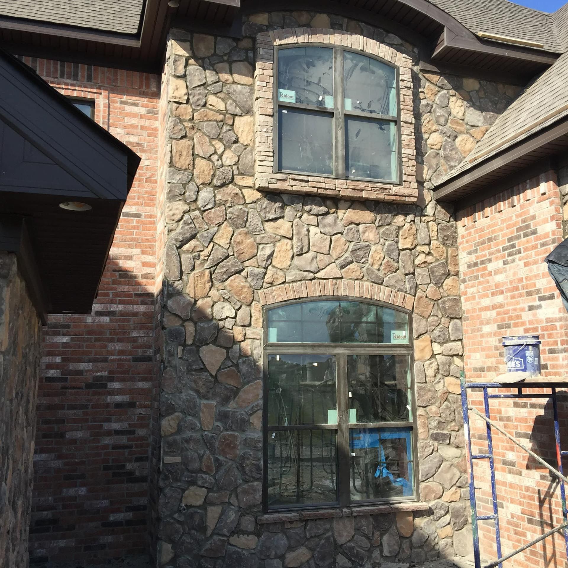 A brick building with a stone wall and a window