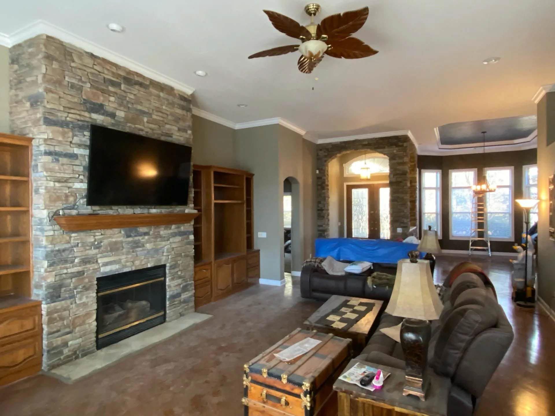 A living room with a fireplace and a flat screen tv