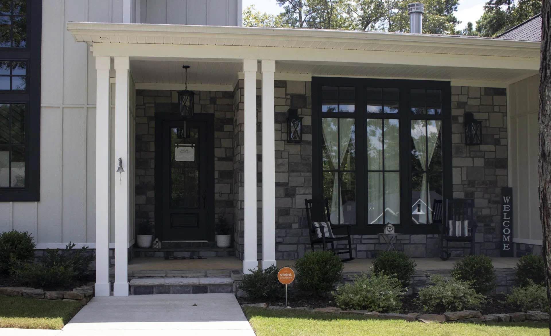 A house with a porch and a sign that says welcome