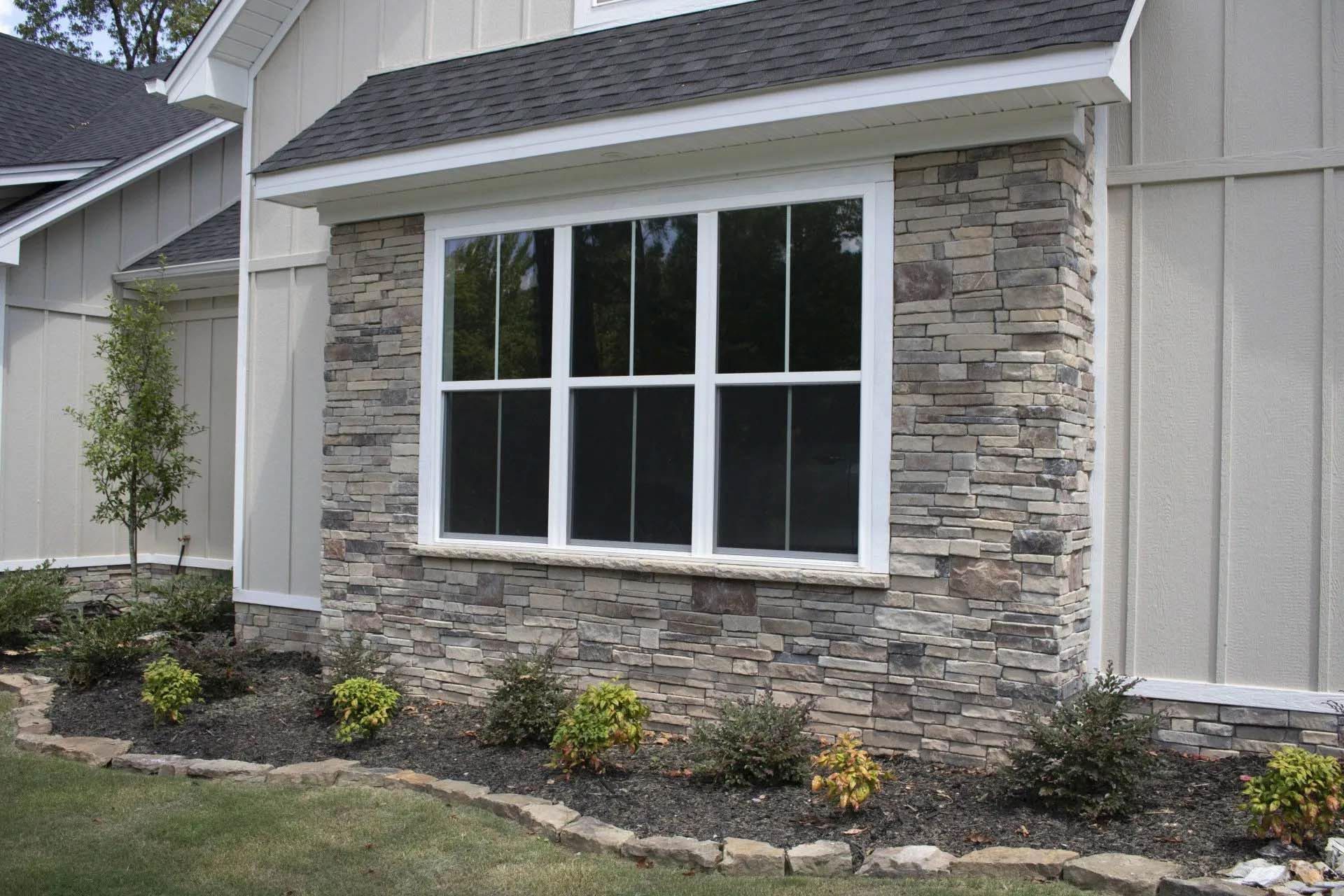 A house with a large window on the side of it.