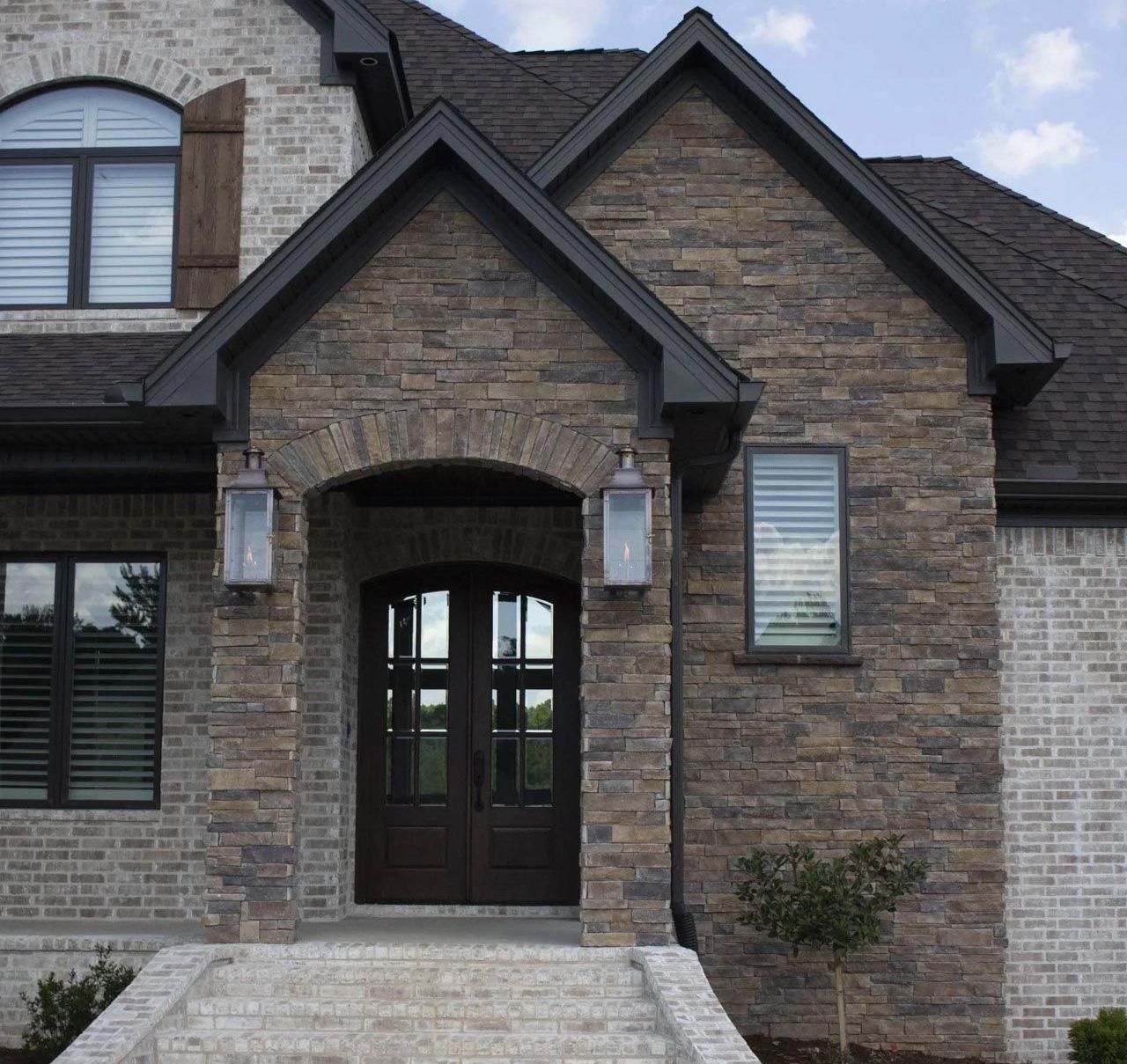 A large brick house with a black roof