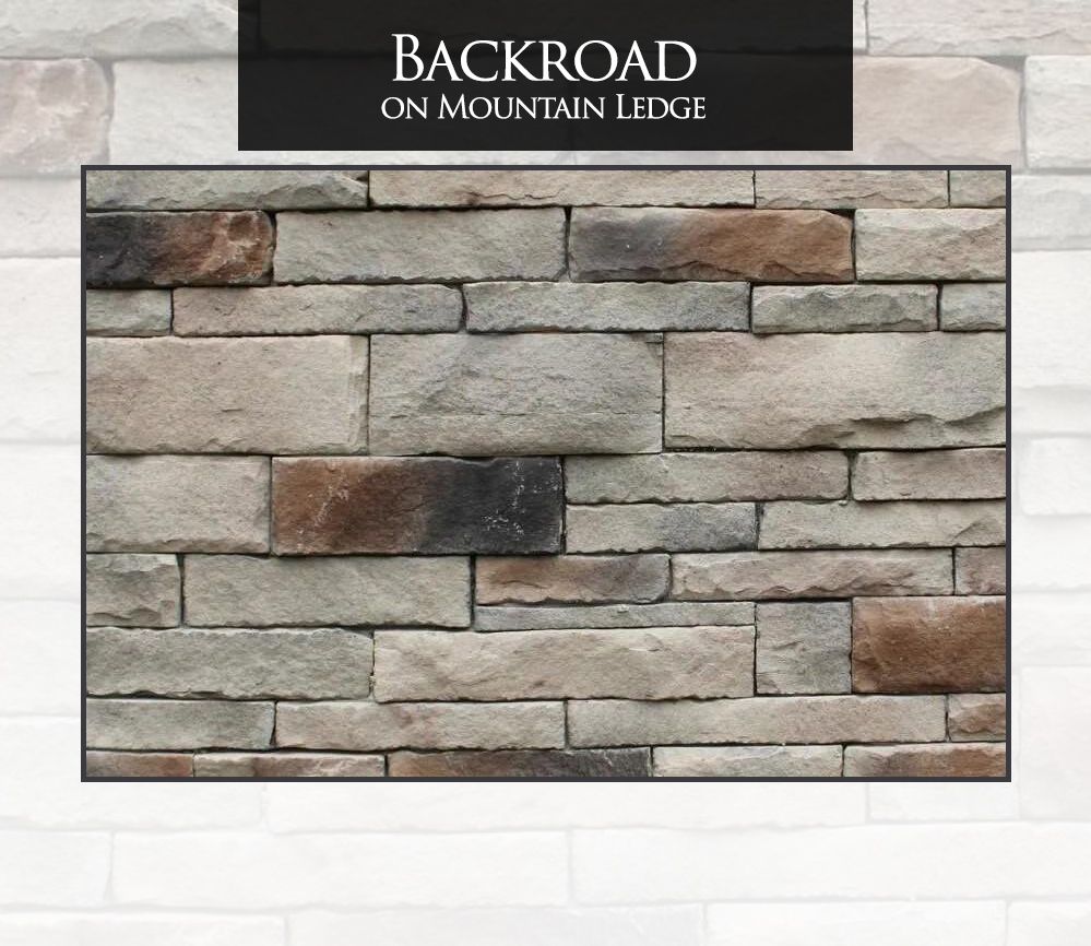 A brick wall with a sign that says backroad on mountain ledge