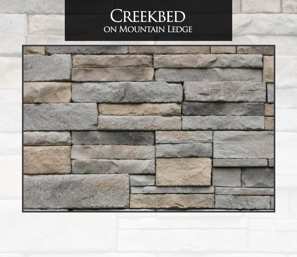 A picture of a stone wall that says creekbed on mountain ledge
