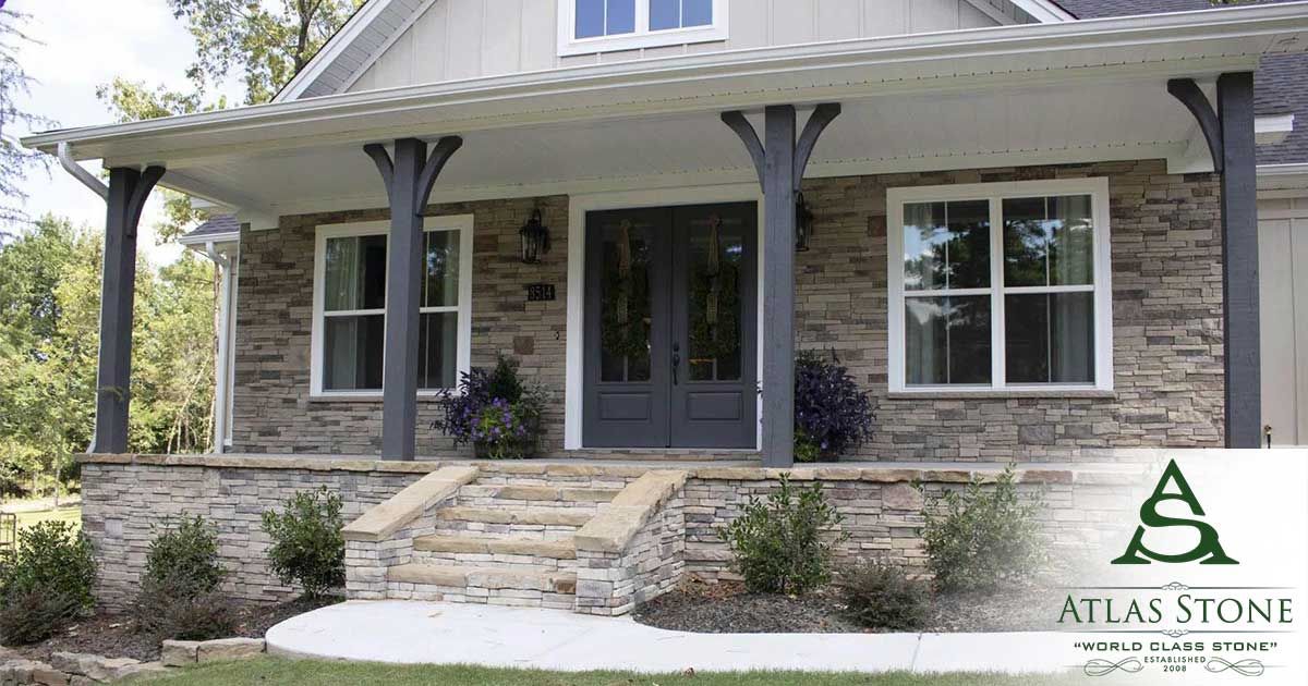 A house with a porch and a logo for atlas stone