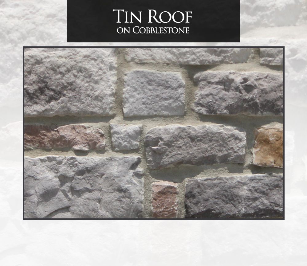 Gray and tan cobblestone wall with the words “Tin Roof on Cobblestone” on top.