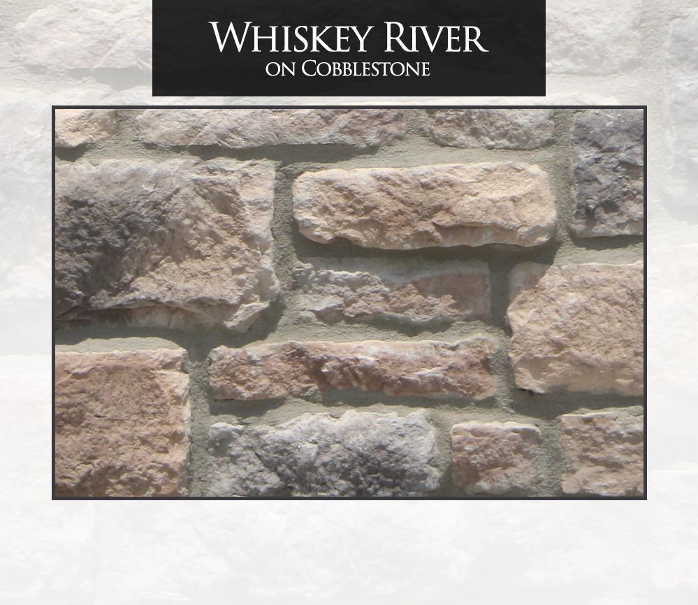 Whiskey River on Cobblestone: Close-up of textured stone wall in various earth tones, with mortar.