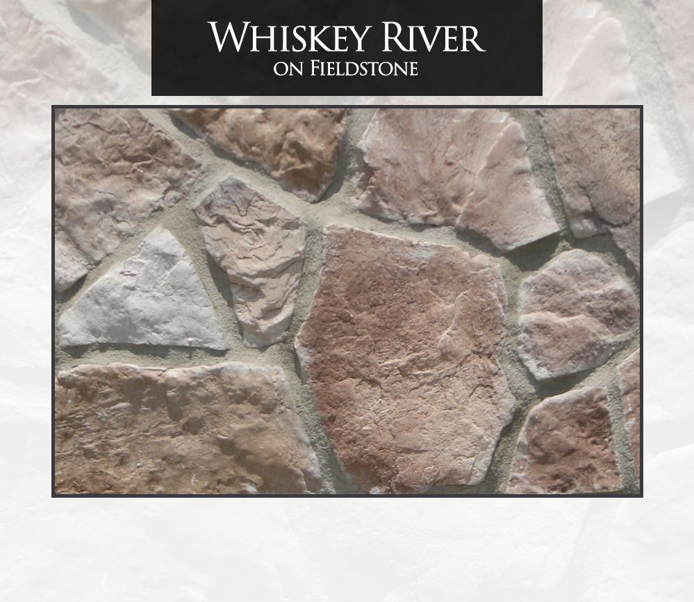 Whiskey River fieldstone wall with brown, tan, and grey stones set in mortar.