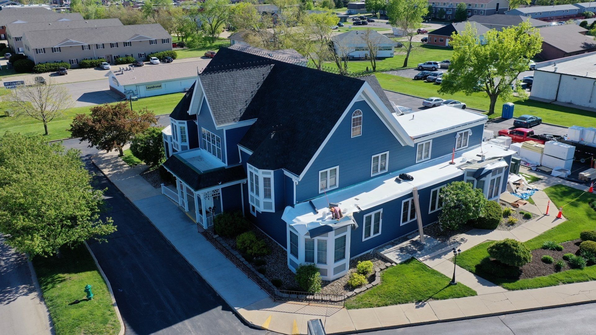 an aerial view of a large blue house