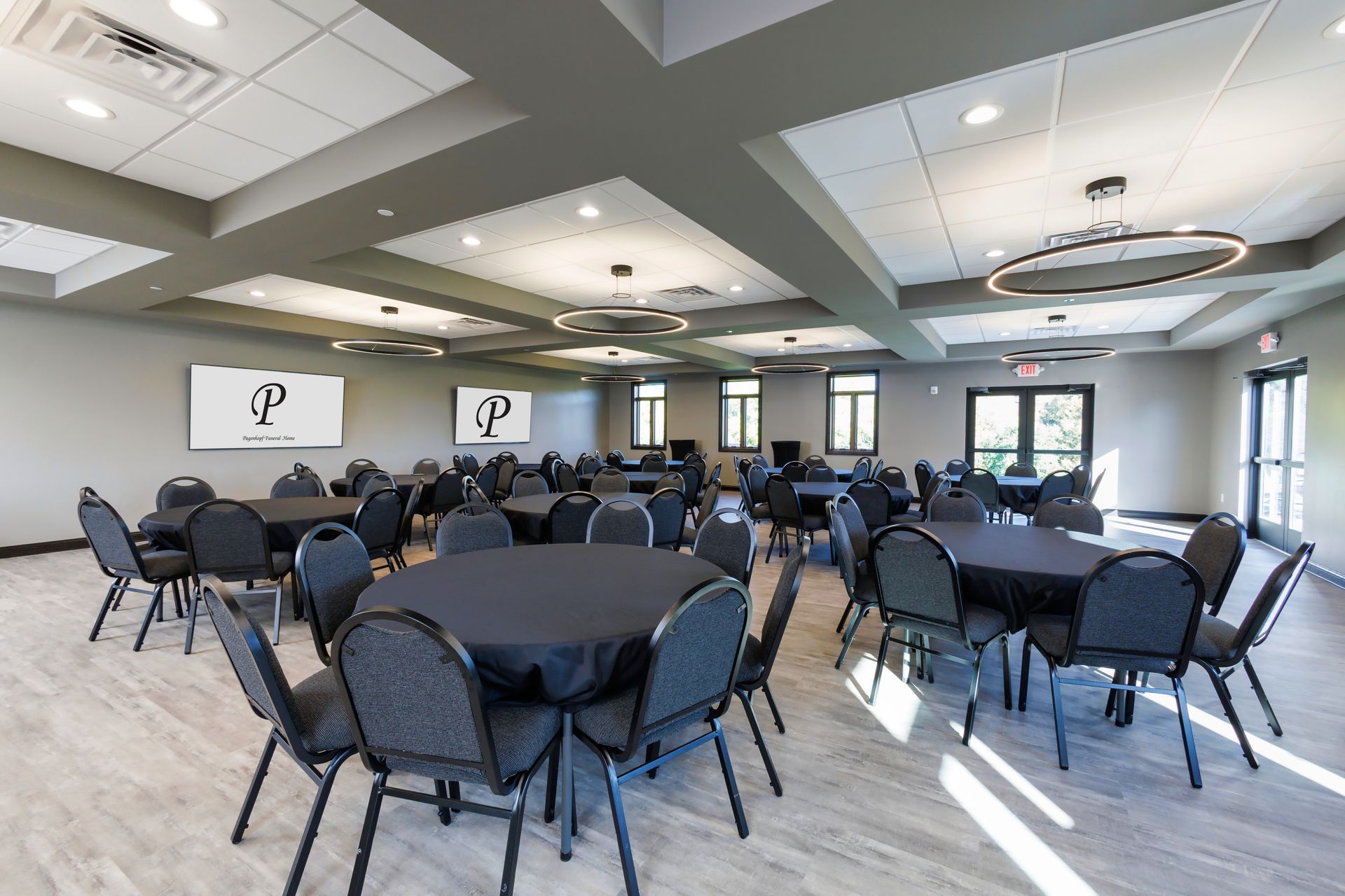 A large room with tables and chairs in it.