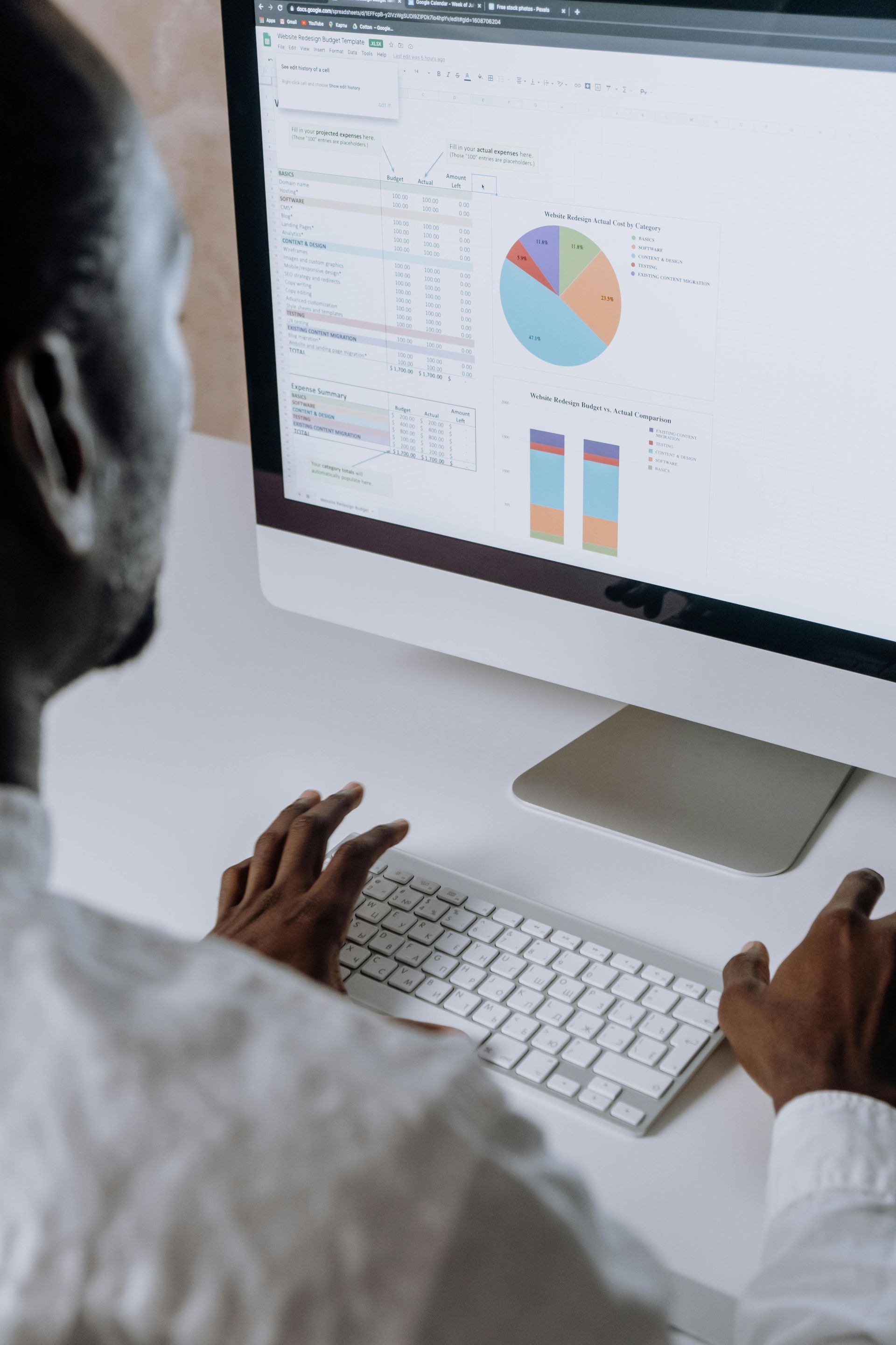 A man is using a computer with a pie chart on the screen.