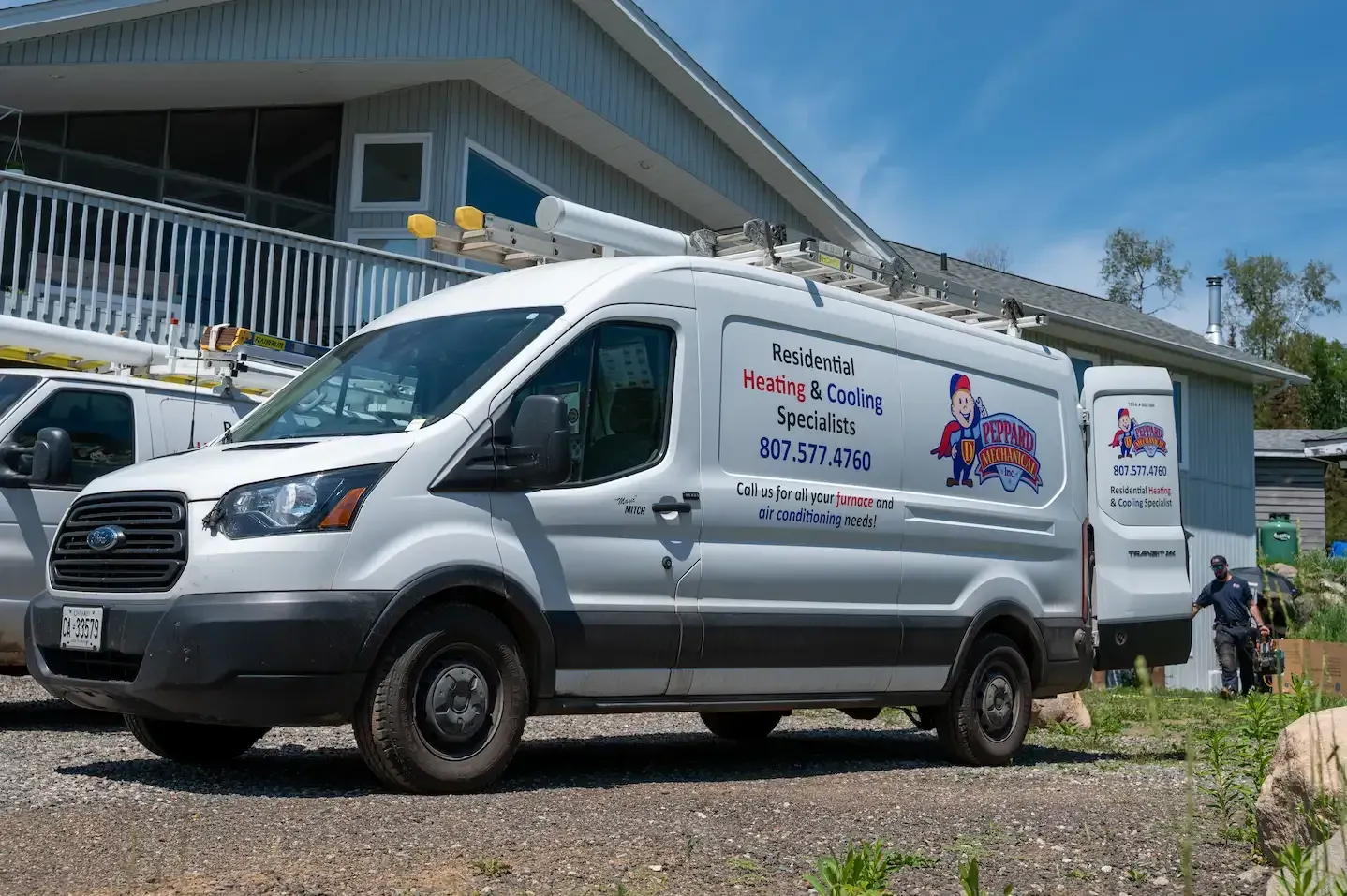 Technician fixing air conditioner and indoor unit beside a step ladder