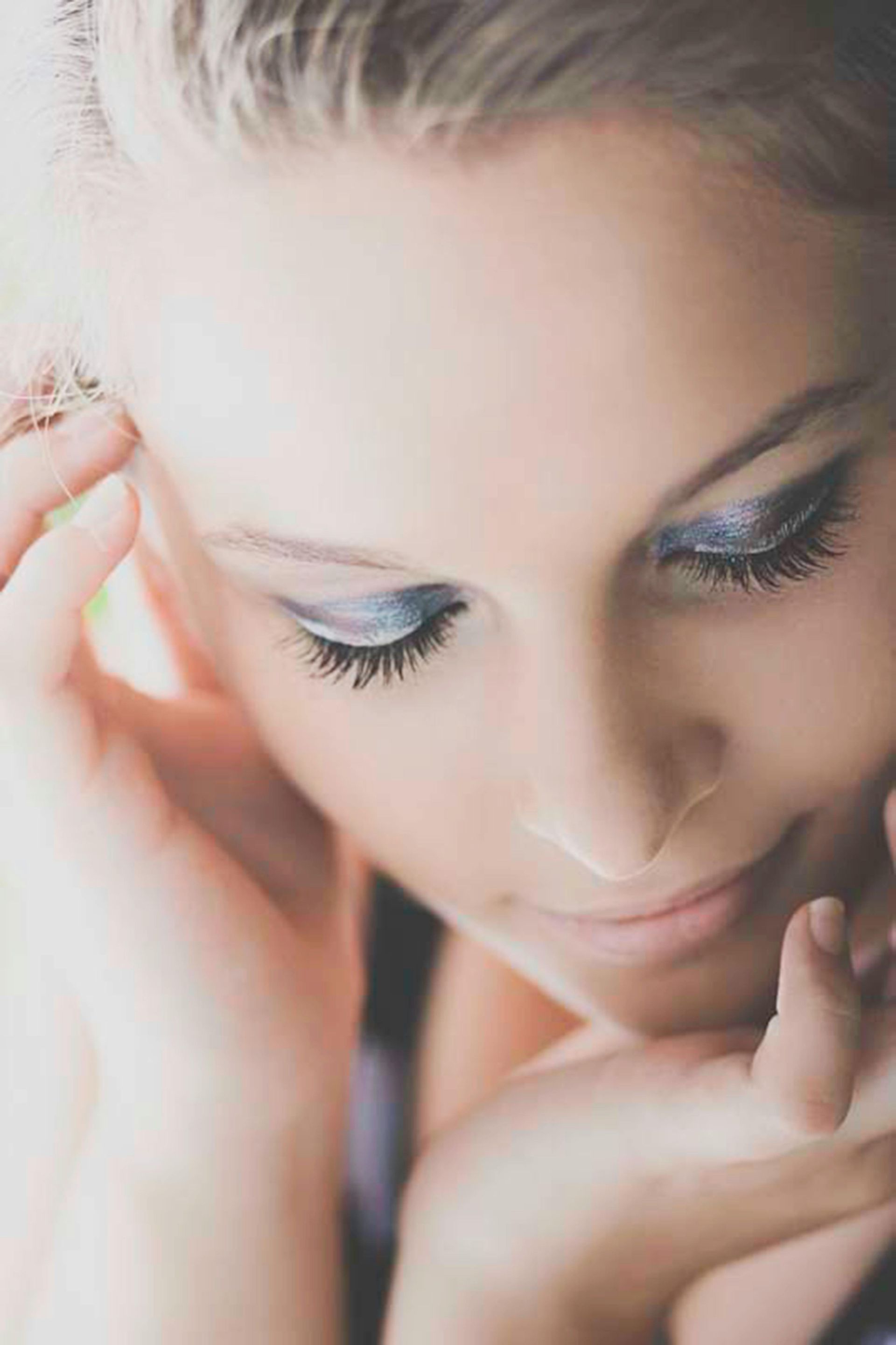 A close up of a woman 's face with makeup on.