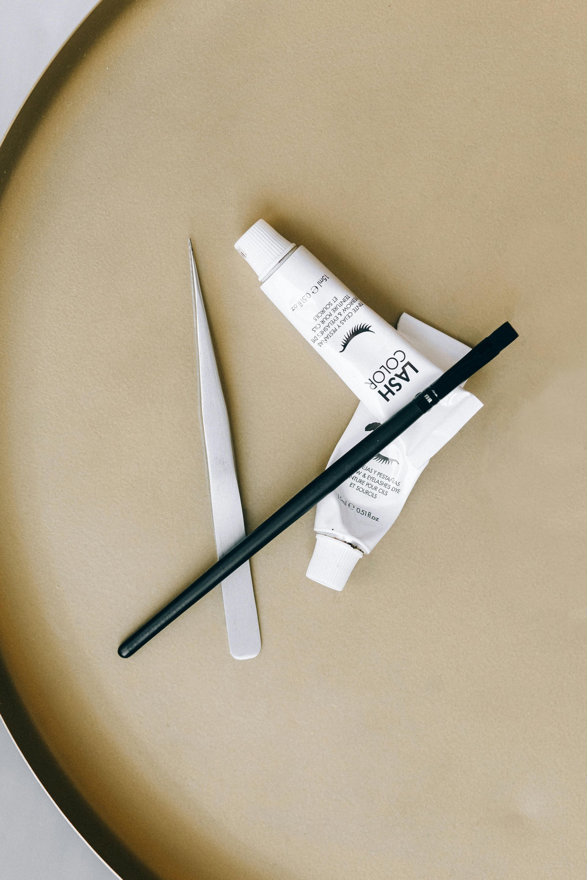 Two tubes of paint and a brush on a table