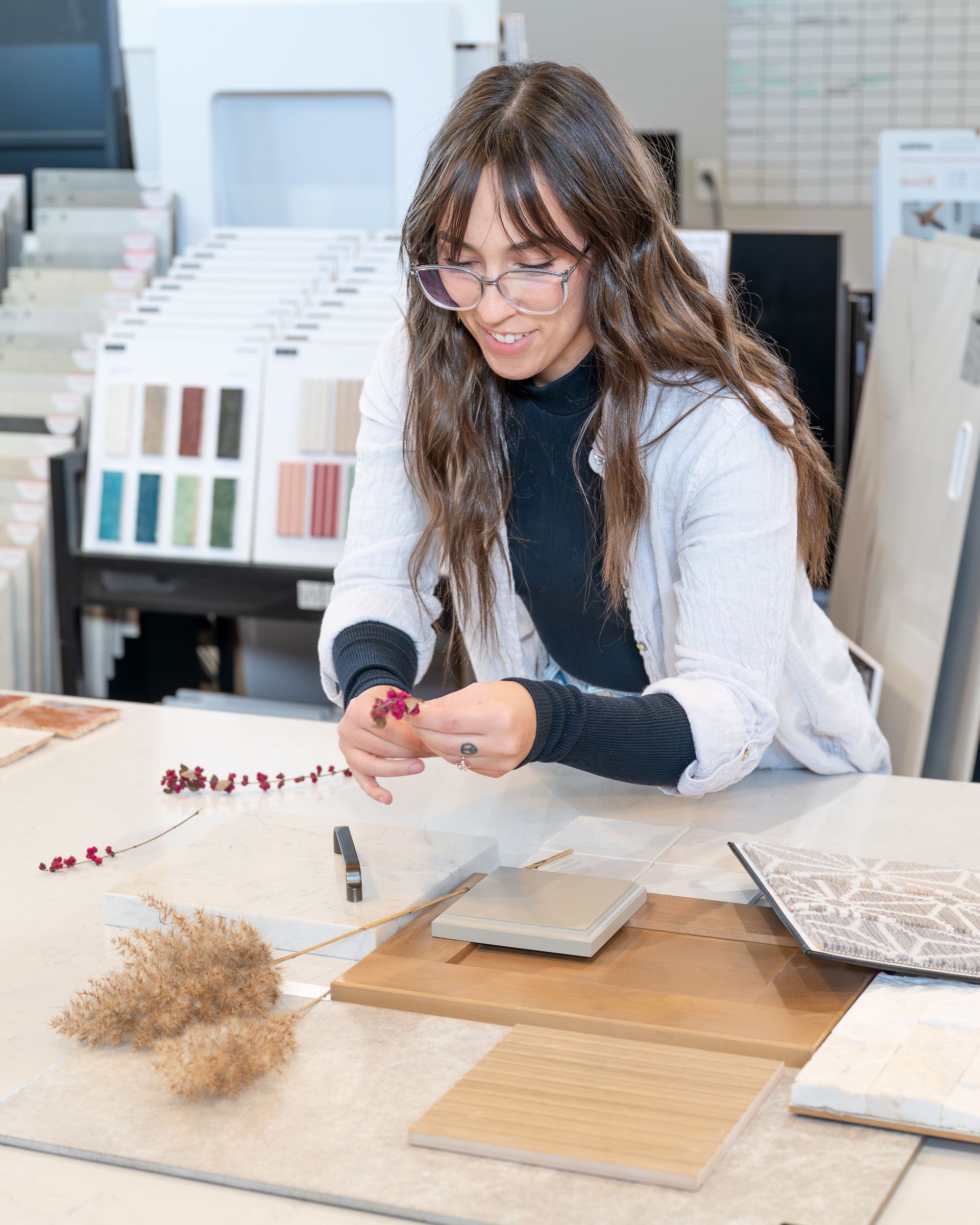 A kitchen with white cabinets , stainless steel appliances , and a large island.