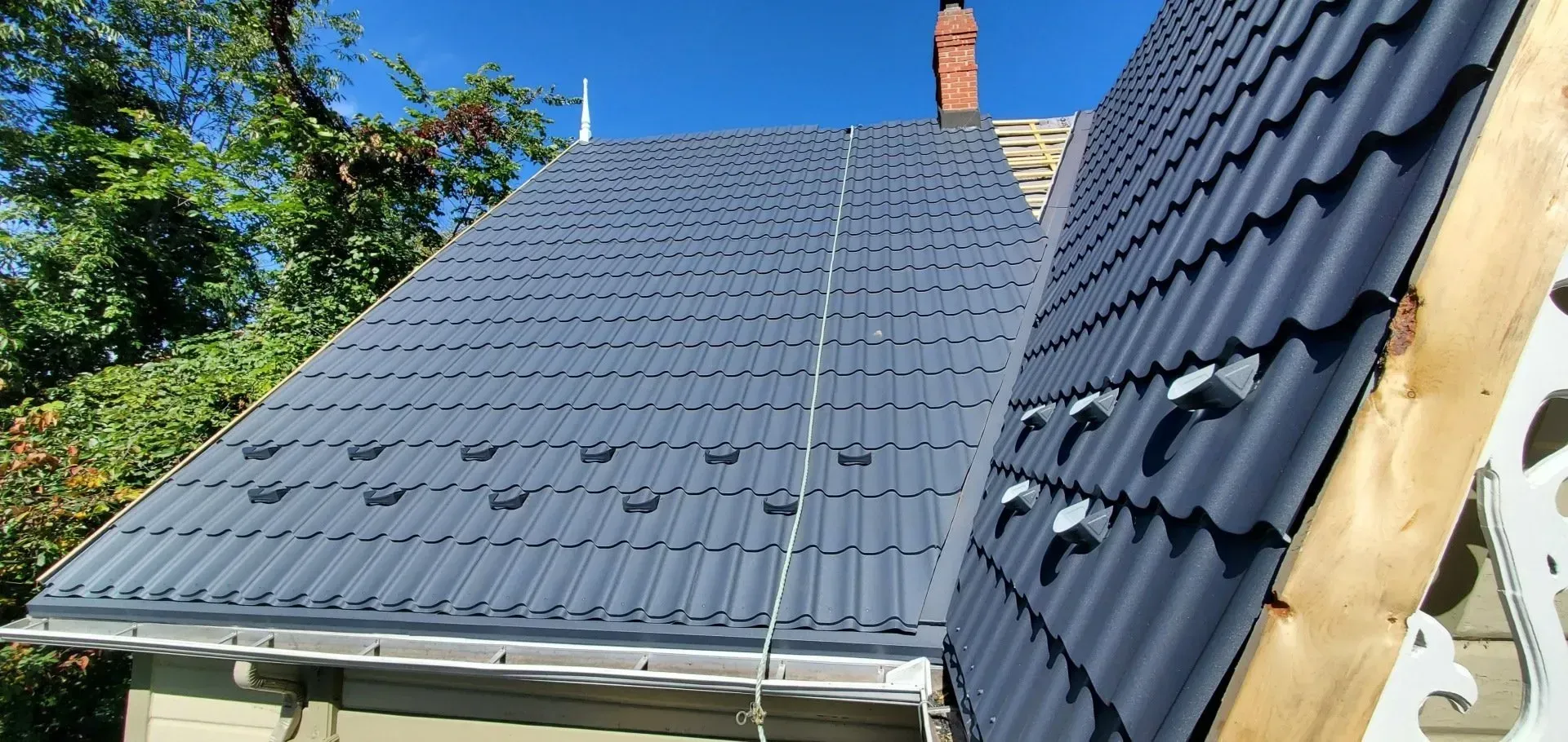 Un toit noir est en cours d'installation sur une maison.