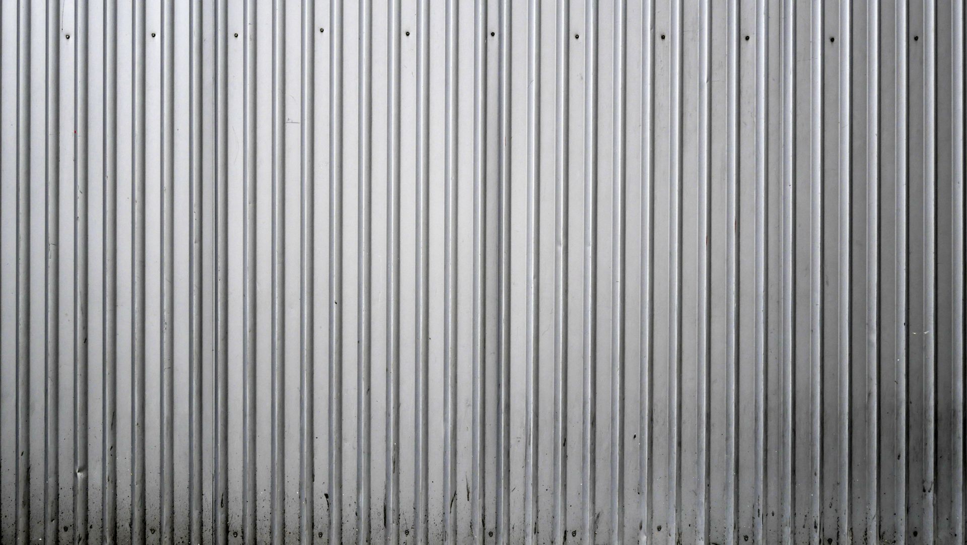 A close up of a gray corrugated metal wall.
