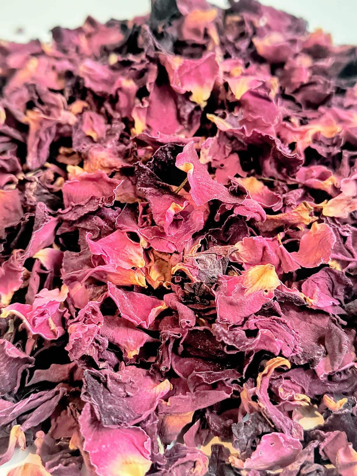 Una bolsa transparente de pétalos de rosa rojos secos con una etiqueta