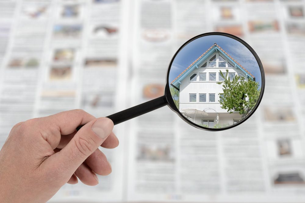 Person Looking At A House Through A Magnifying Glass — Pro Vision Property Inspections In Lambton, NSW