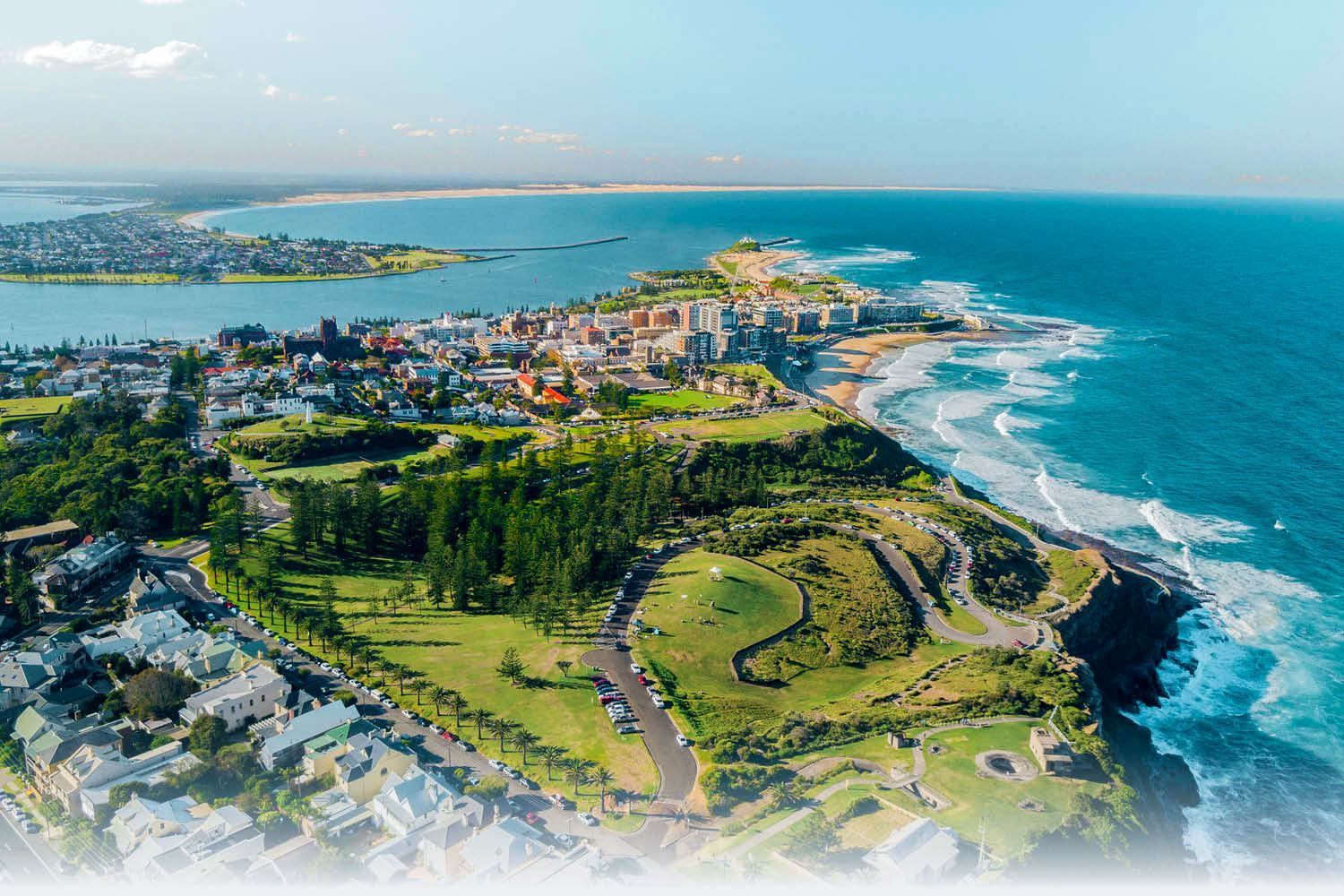 Aerial View Of A City With A Large Body Of Water — Pro Vision Property Inspections In Newcastle, NSW