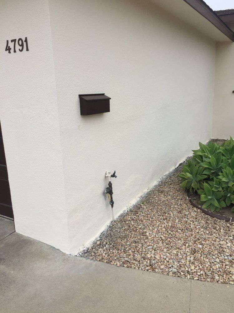 A white house with a mailbox on the side of it.