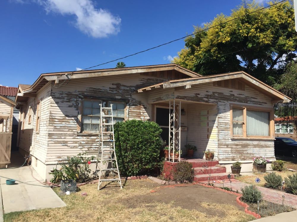 A white house with a ladder in front of it