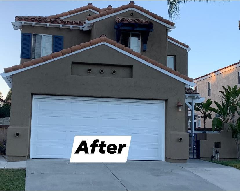 A house with a white garage door and a sign that says after