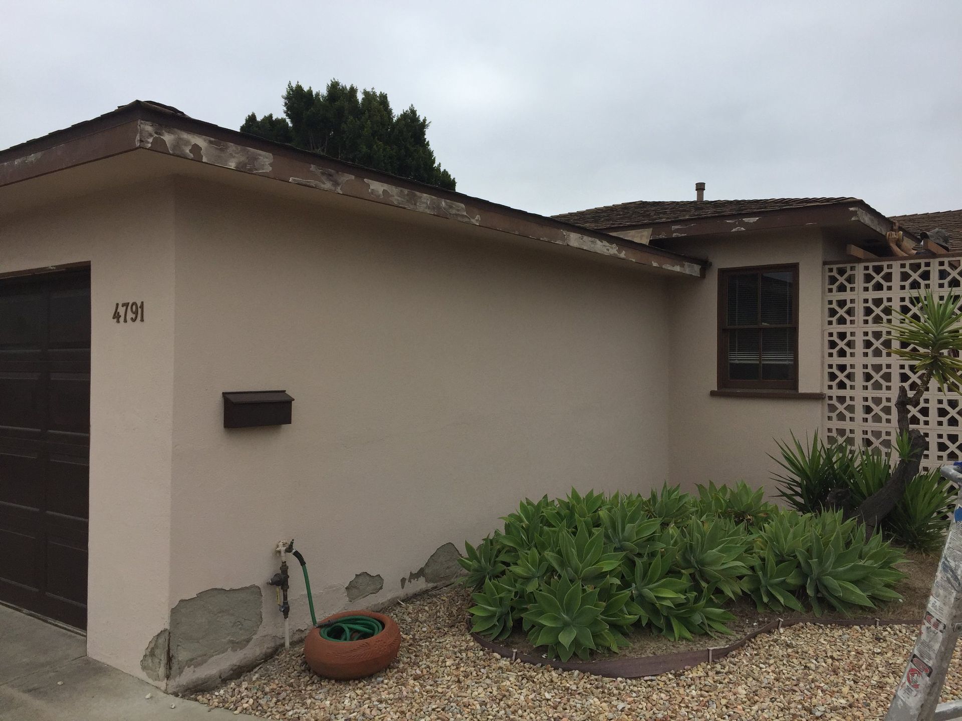 A house with a garage and a mailbox on the side of it